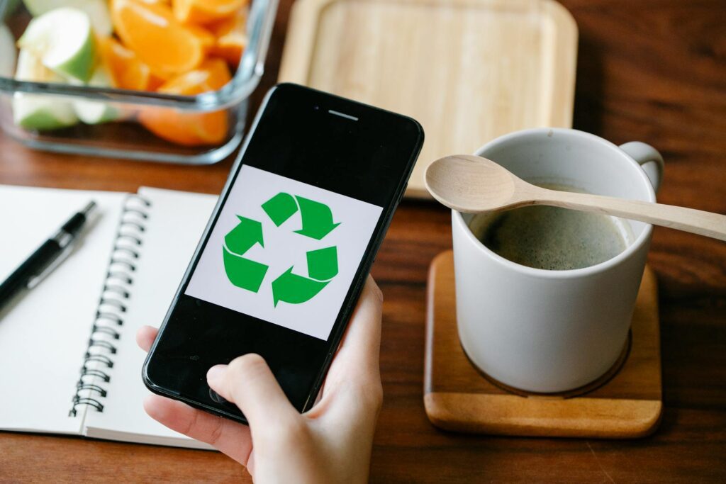 A person using a smartphone to access green banking apps that support eco-friendly actions 