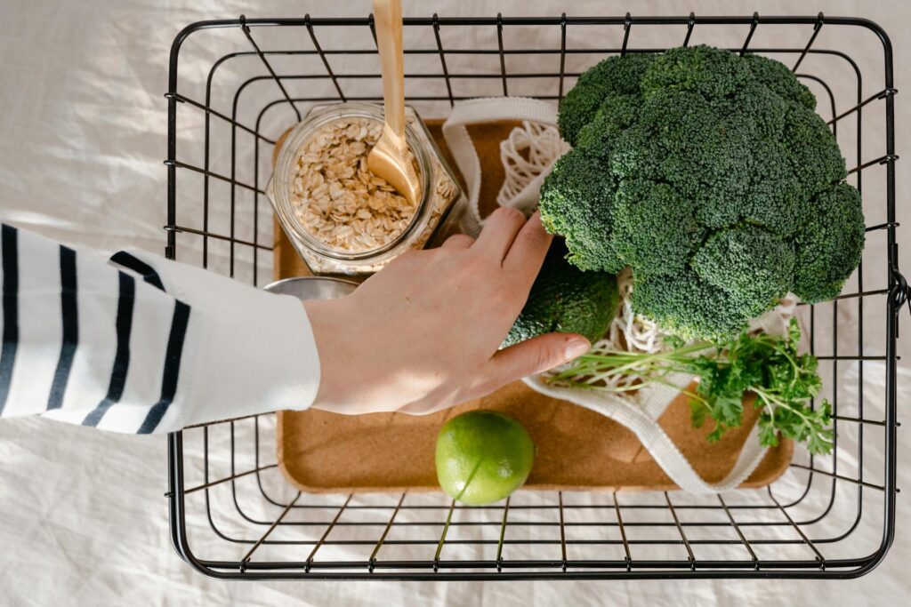 Climate conscious shopper with sustainable products in shopping basket thanks to carbon footprint labels